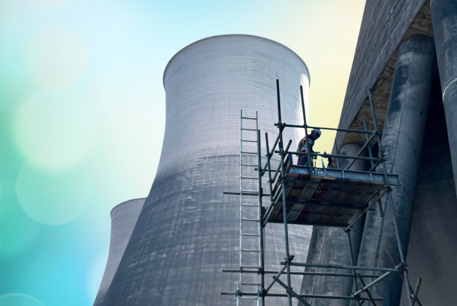 Natural-draft cooling towers at the Laos coal-fired power plant with scaffolding erected against the shell for fill replacement