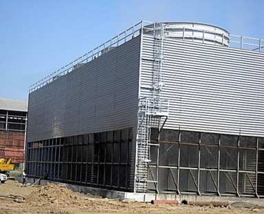 A new FRP counterflow cooling tower with a ladder up its side, on a plant site