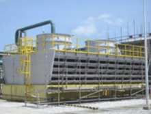 A reconstructed cooling tower with yellow safety railings and fan stacks