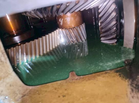 Open cooling-tower drive gearbox at the Songkhla site showing the bevel and helical gear set inside the housing during inspection